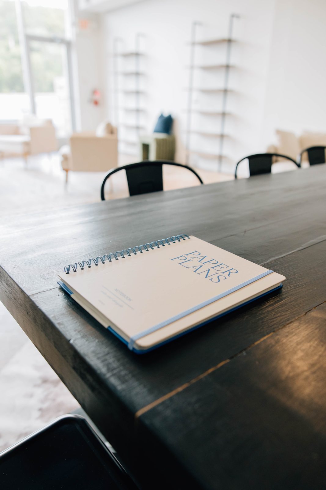 A planner on the dark wood table, a styled corner for content days