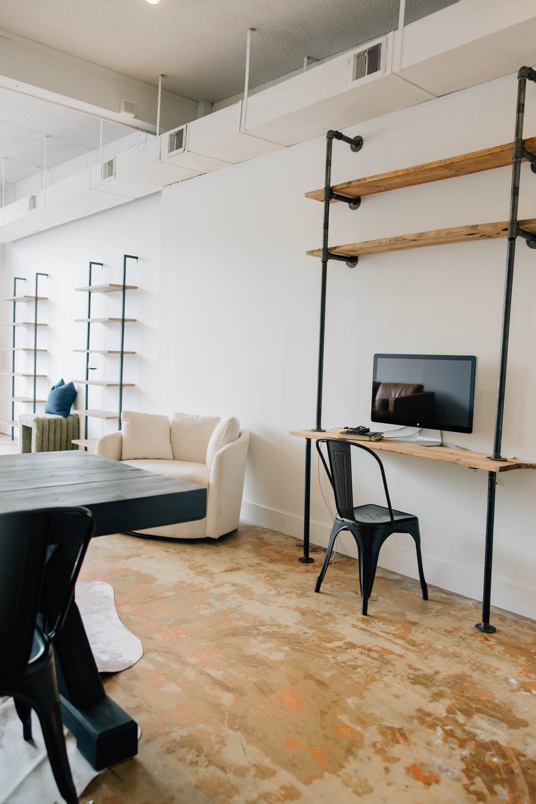 Desk and armchair against open shelving