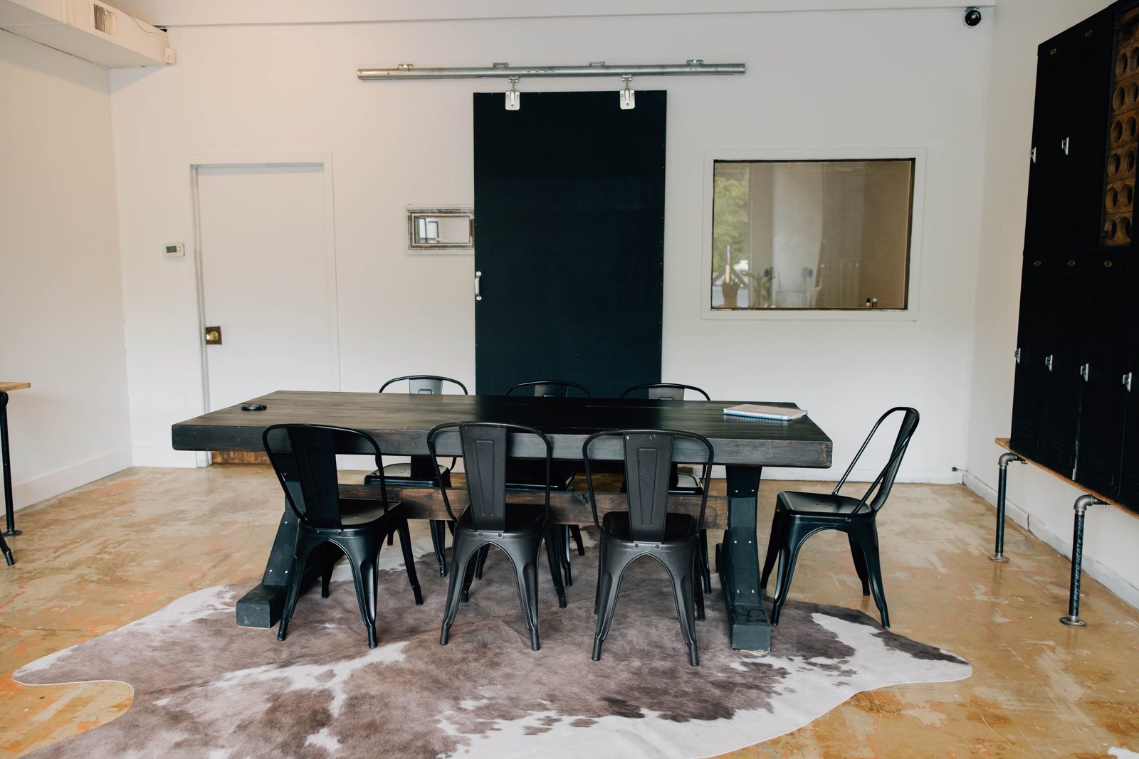 Conference table seating eight with black metal chairs
